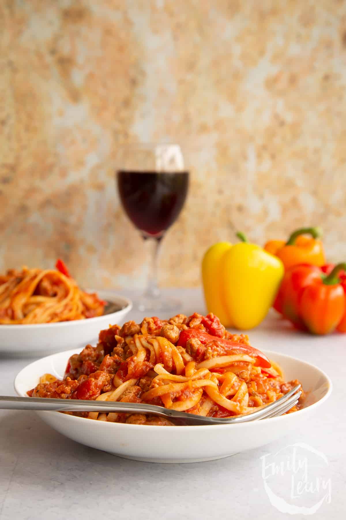 One pot vegan bolognese in a shallow white bowl with a fork.