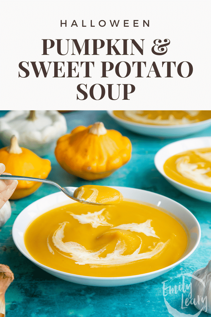Pumpkin and sweet potato soup in a white bowl. The soup has cream swirled on top to resemble a jack'o'lantern. A hand holds a spoon, lifting some soup. Caption reads: Halloween Pumpkin and sweet potato soup