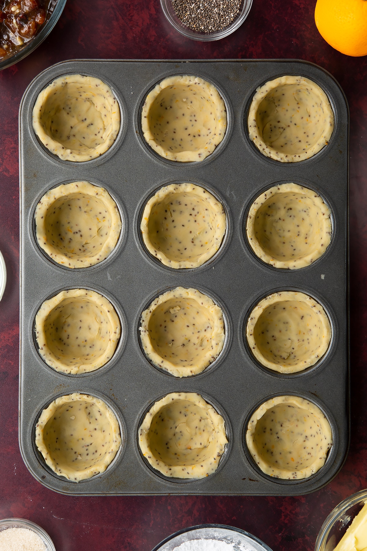12-hole muffin tray lined with vegan pastry.
