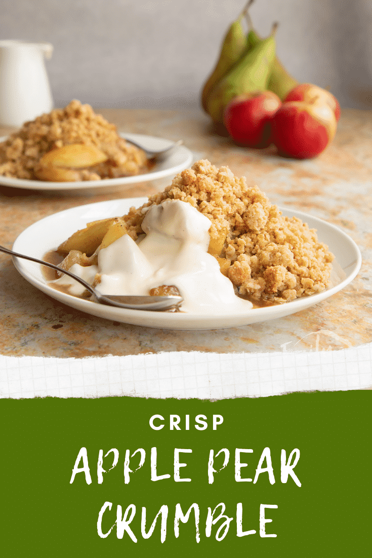 Apple pear crumble and custard served to a small white plate with a spoon. Caption reads: Crisp apple pear crumble.