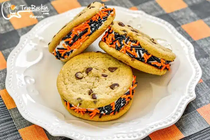 Halloween cookie sandwiches decorated with orange and black sugar stands.