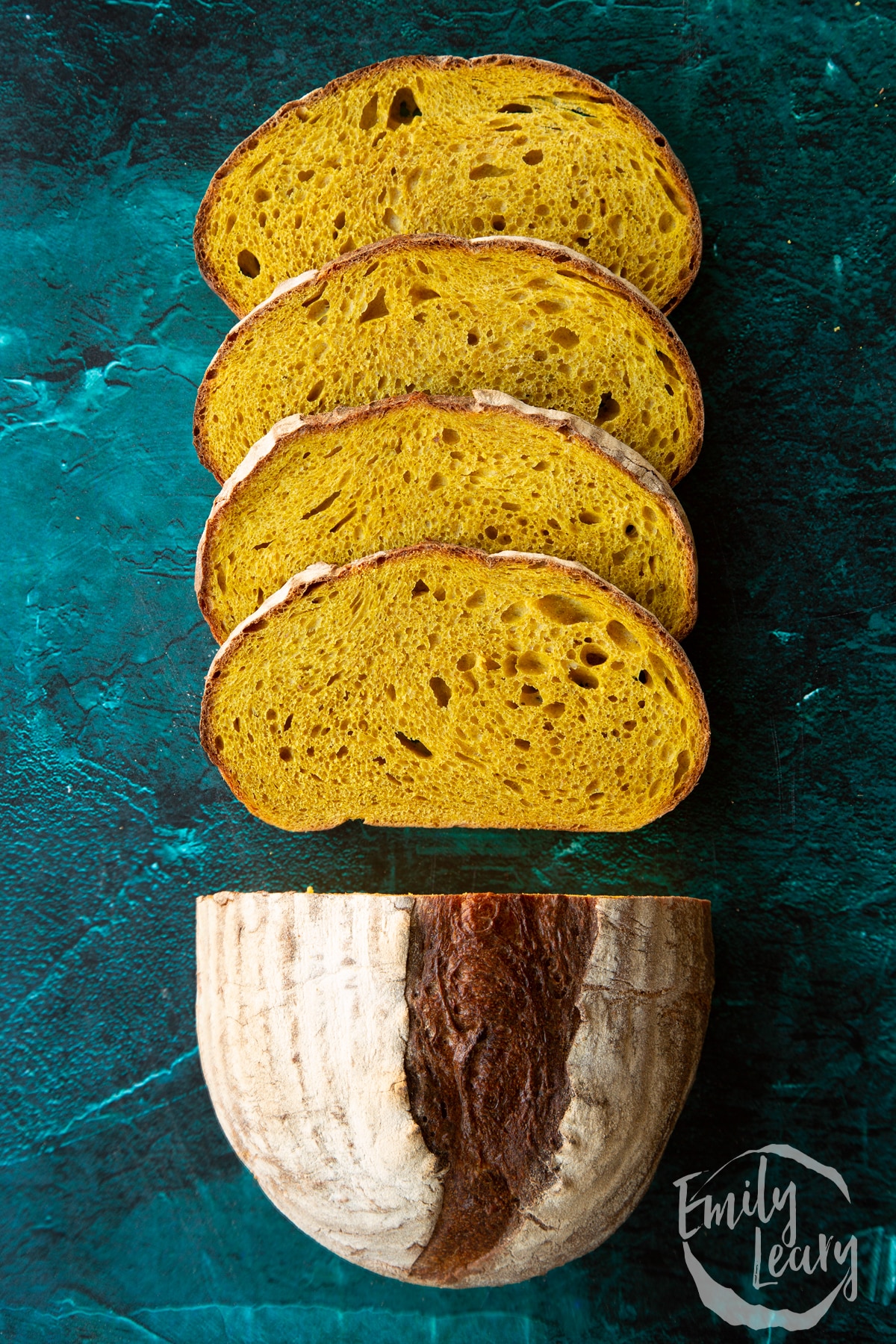 Pumpkin sourdough bread. Some has been cut into slices.