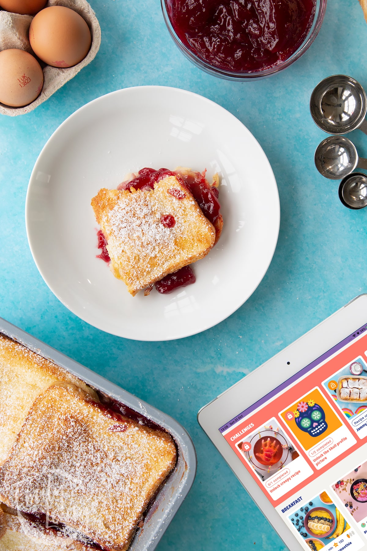 Overhead shot of a bowl of finished bread and butter pudding with jam.