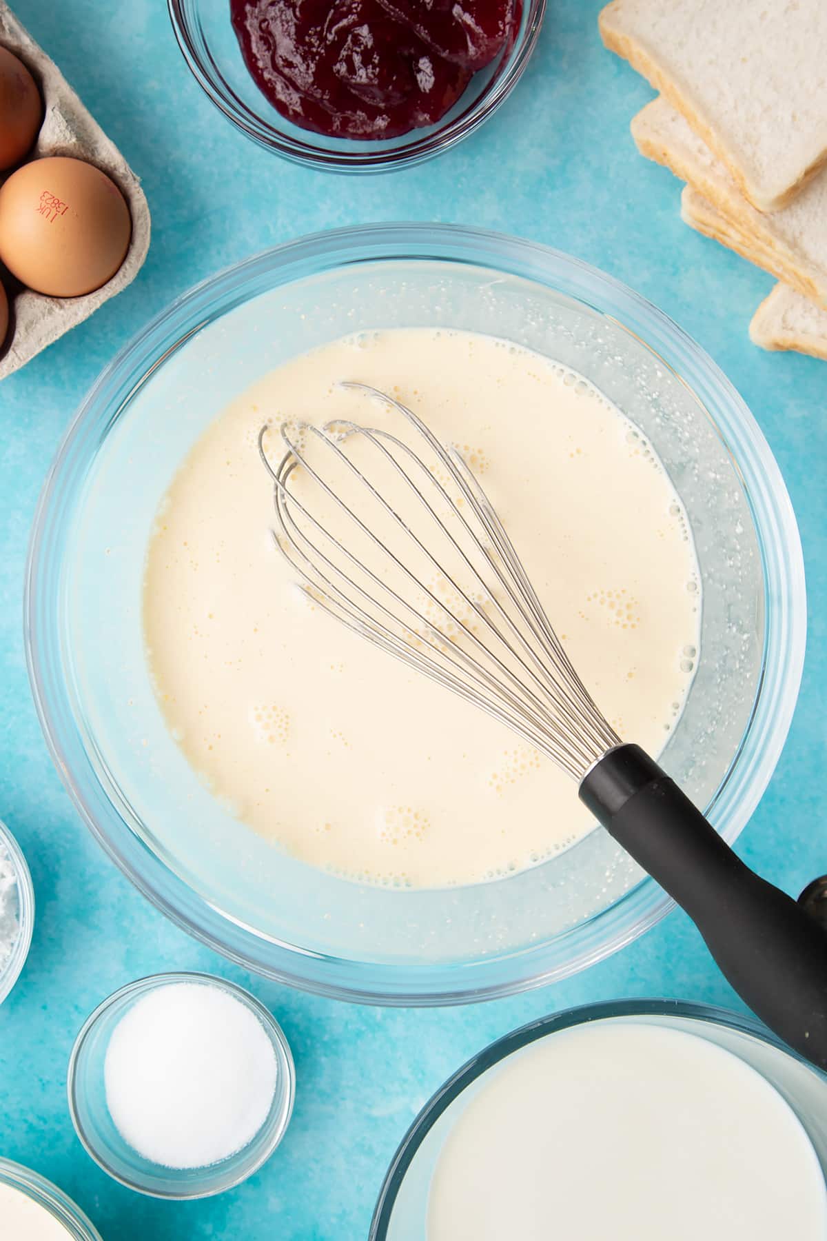 Whisk in a bowl of the wet batter for the bread and butter pudding with jam.