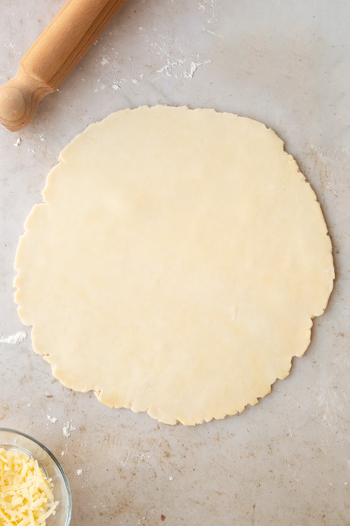 Overhead shot of the pastry for the chestnut quiche having been rolled out on a lightly floured surface.