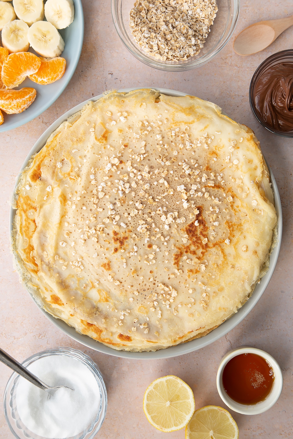 Stack of gluten free crepes on a large grey plate.
