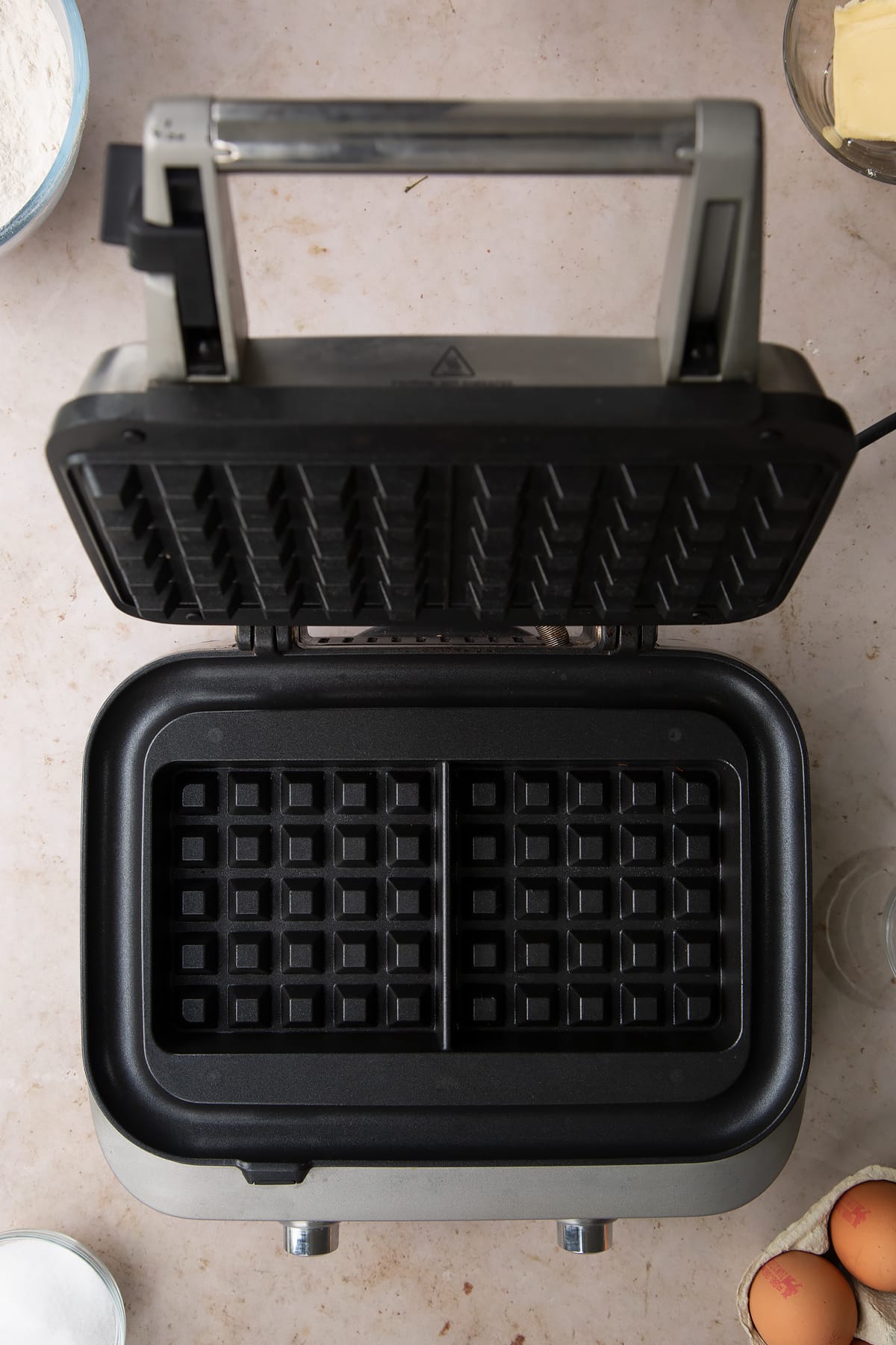 class sage smart waffle maker open on a grey background.