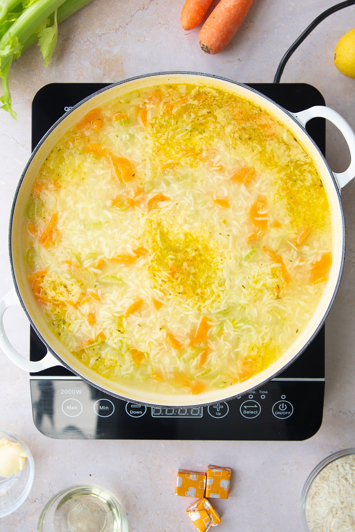 Overhead shot of the turkey rice soup pan of ingredients having been cooking for a couple of minutes.