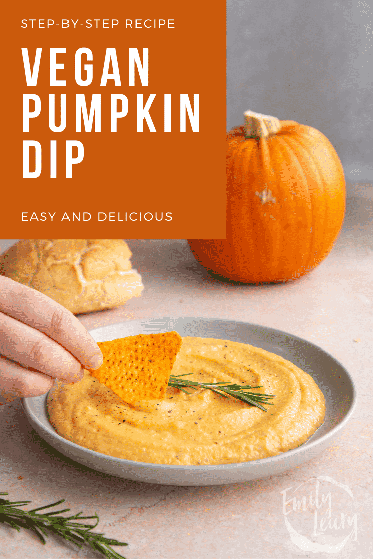 Vegan pumpkin dip in a shallow grey bowl with a sprig of rosemary. A hand dips a tortilla chip into it. Caption reads: Step-by-step recipe. Vegan pumpkin dip. Easy and delicious.