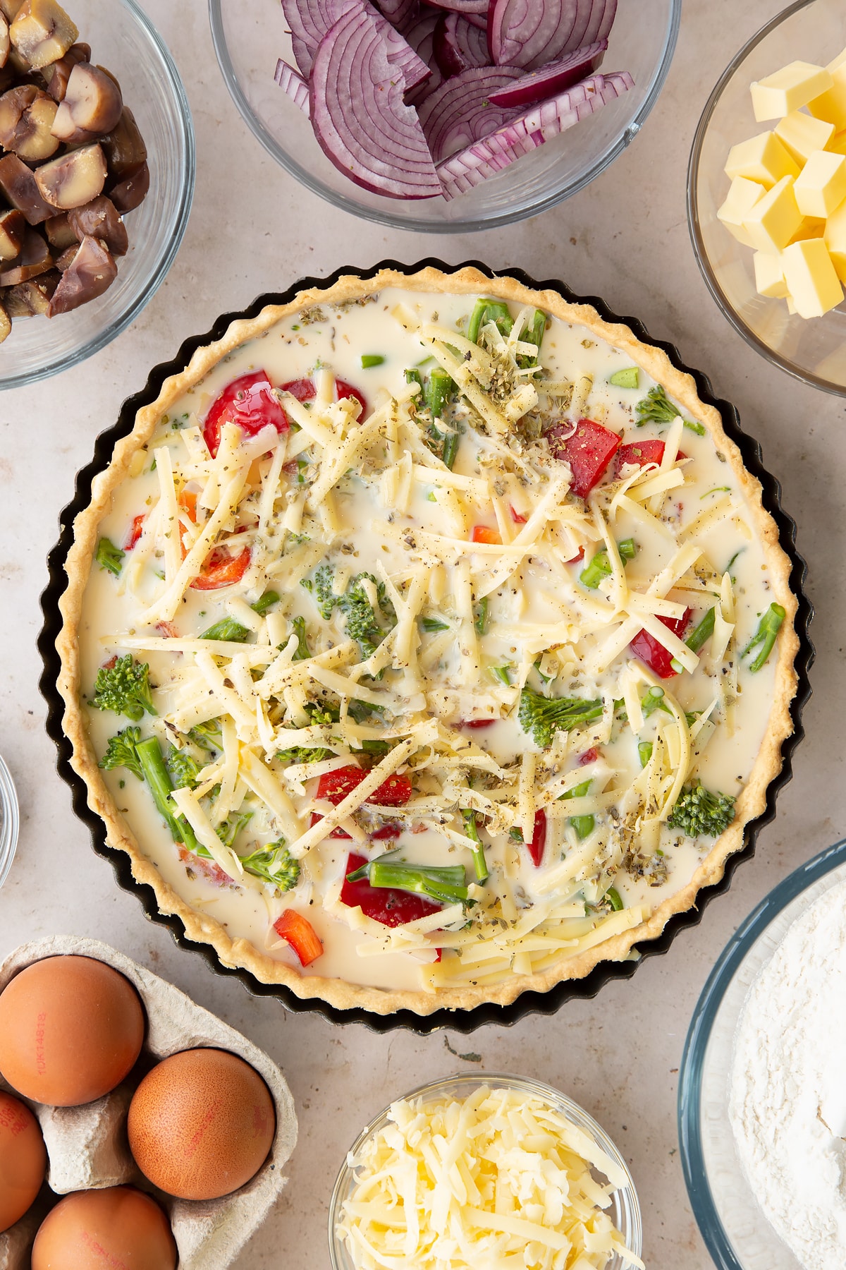 Overhead shot of the raw broccoli and pepper quiche