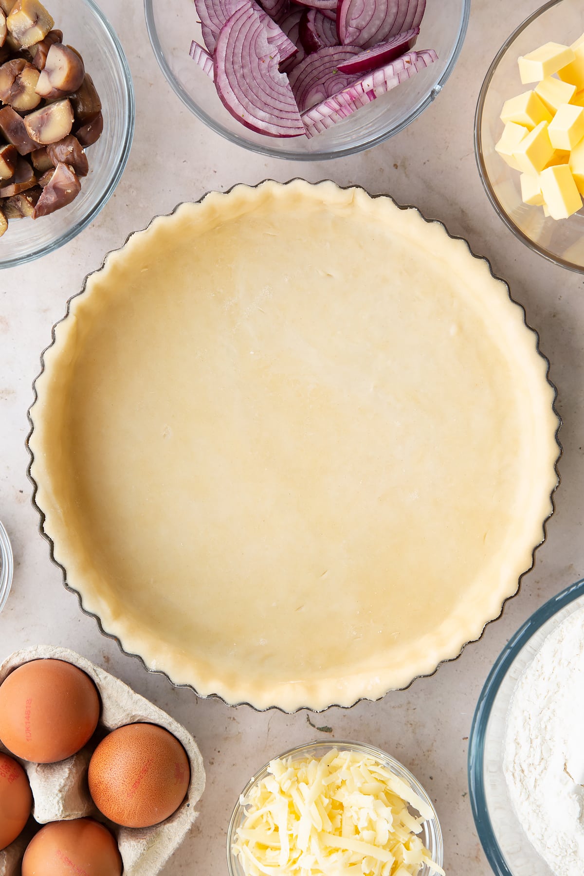 Overhead shot of the finished raw chestnut quiche pastry casing.