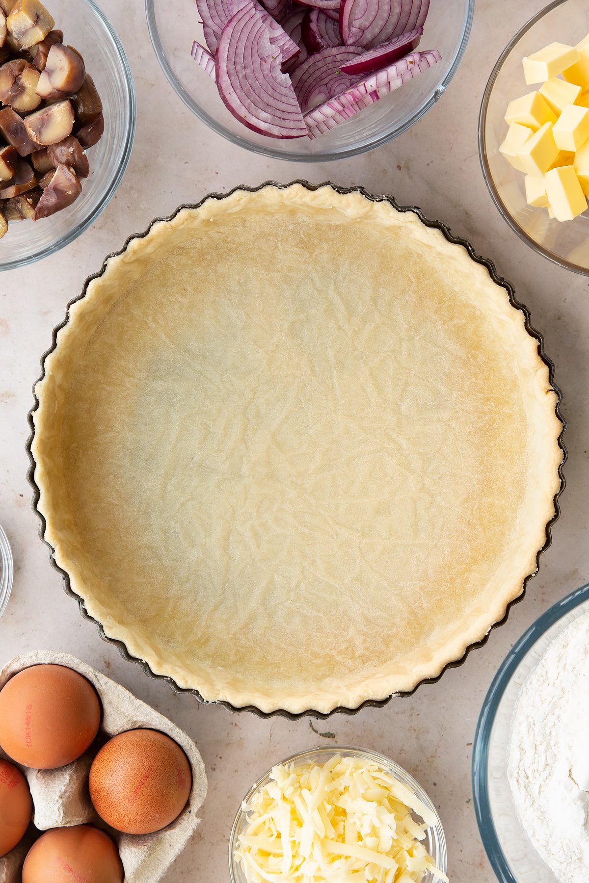 Overhead shot of the chestnut quiche pastry casing having been in the oven for 15 minutes.