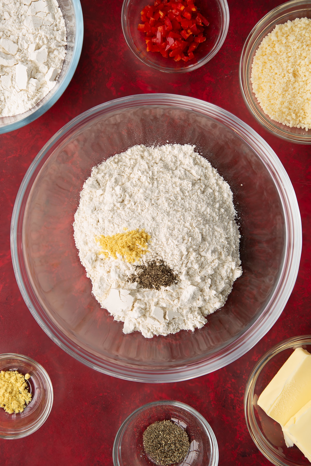 Overhead shot of some of the ingredients for a spicy cheese straws in a mixing bowl.