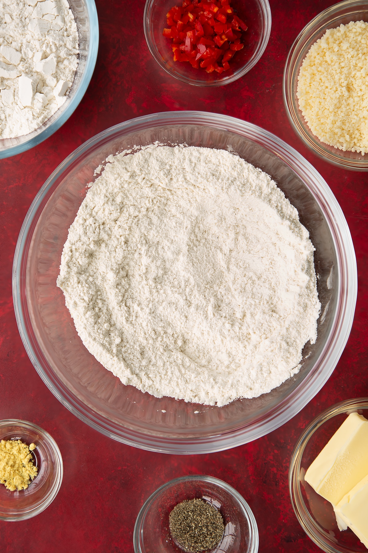 Overhead shot of some of the dry ingredients for the spicy cheese straws mixed together in a mixing bowl.