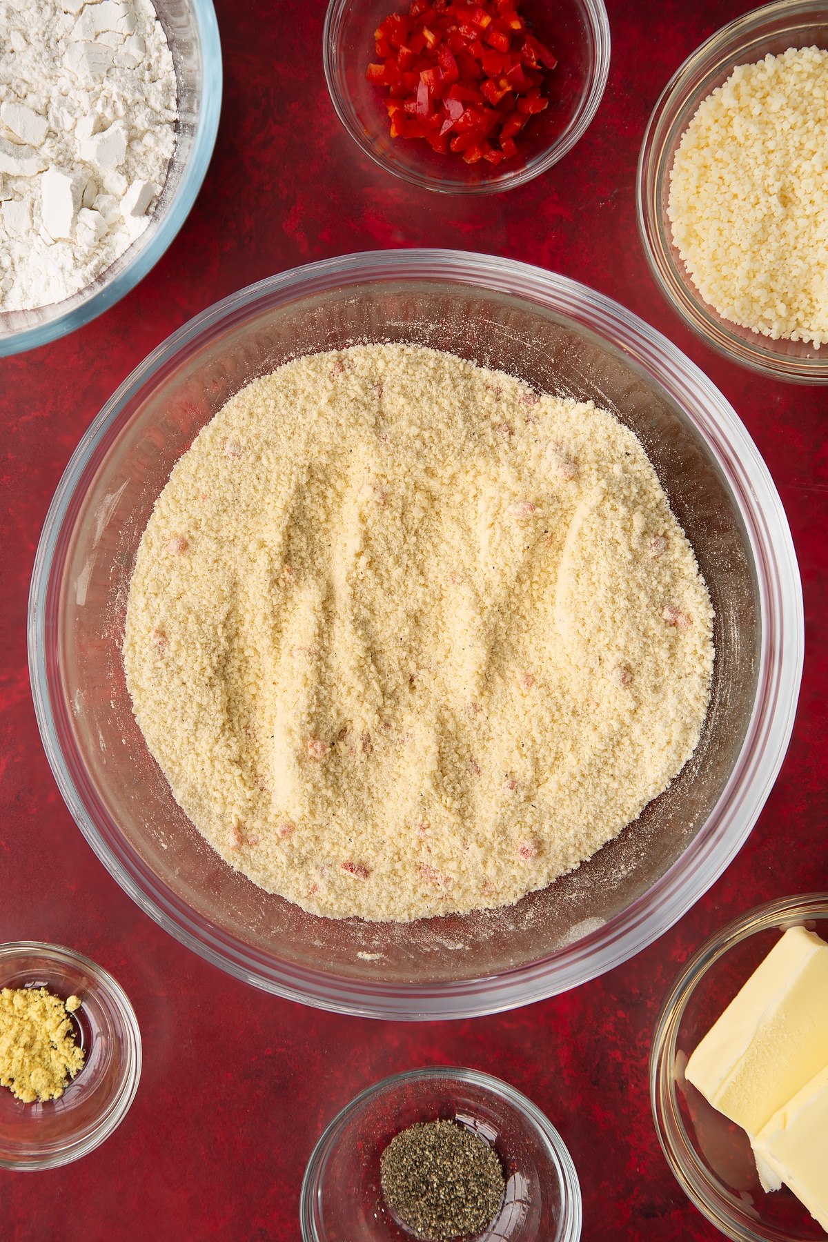 Overhead shot of the spicy cheese straws ingredients having been mixed together in a mixing bowl.