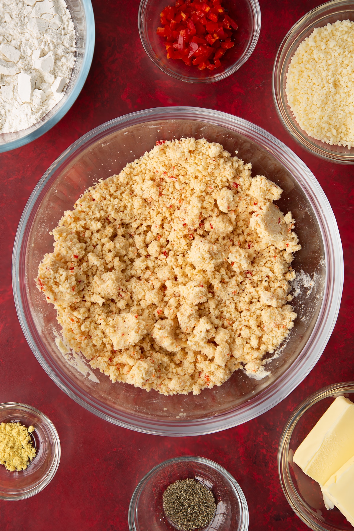 Overhead shot of the spicy cheese straws mixture having been mixed together in a mixing bowl.