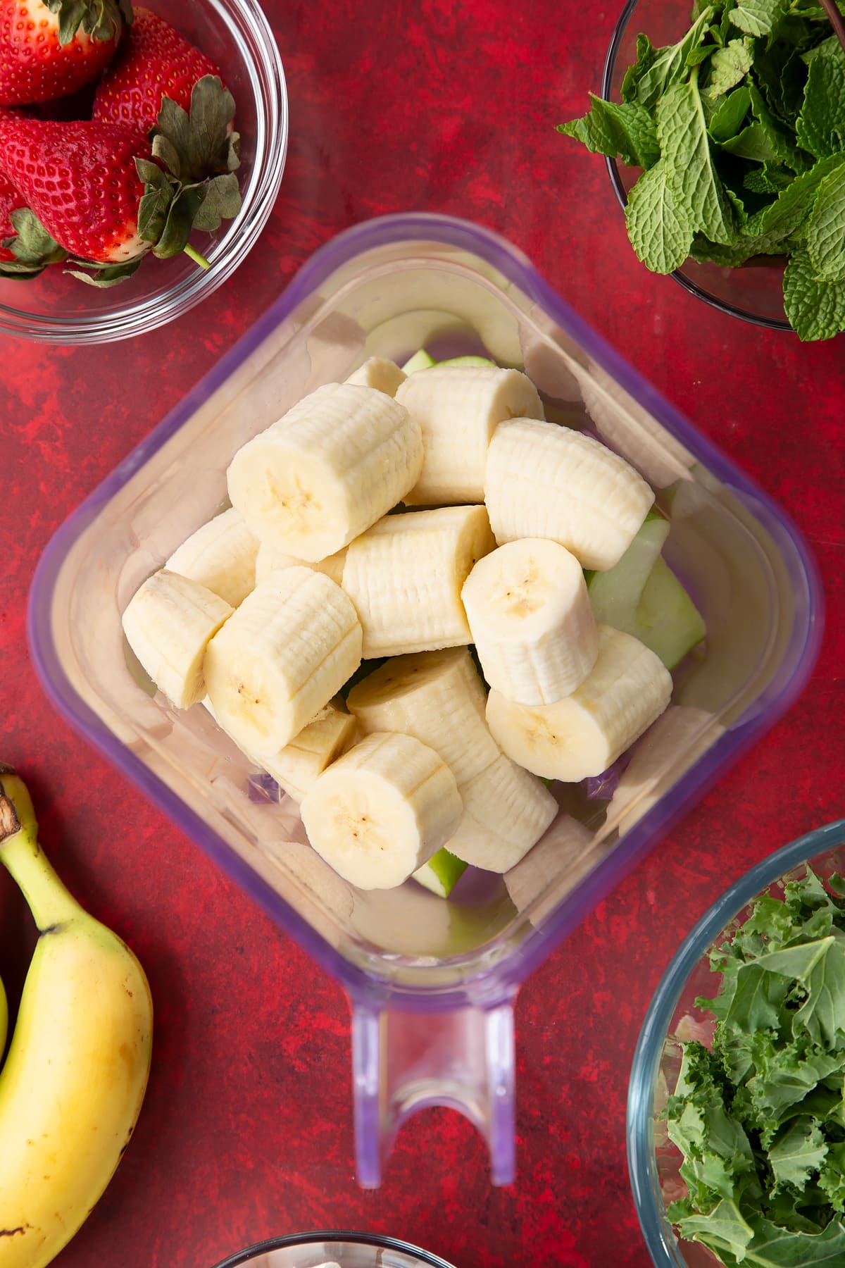 Overhead shot of the banana being added to the blender.