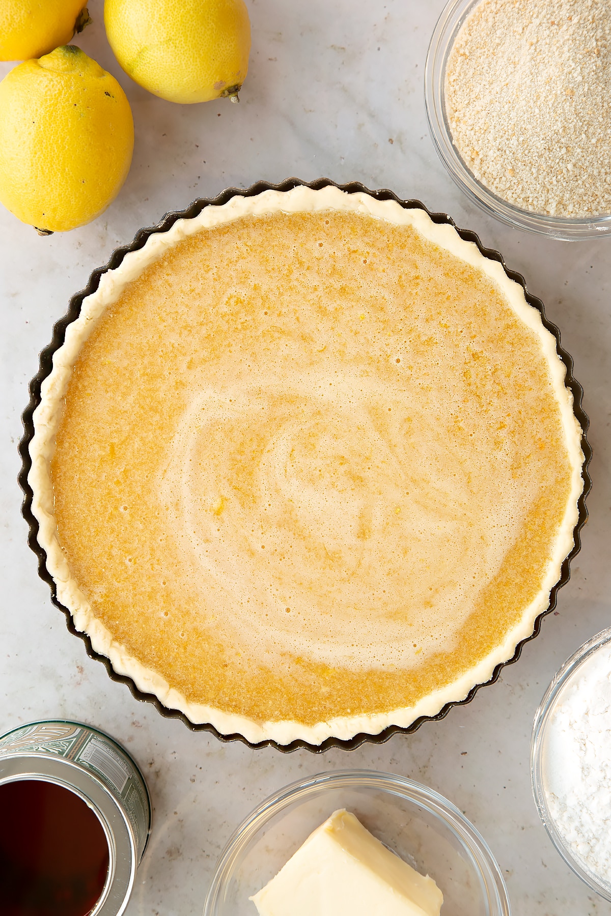 Overhead shot of the pastry case filled with the lemon treacle tart filling.