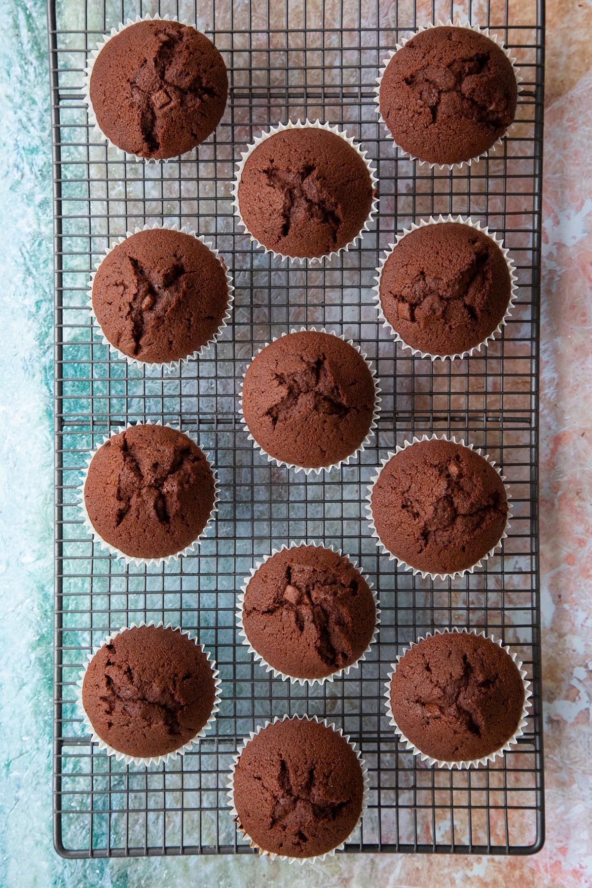 Overhead shot of the mint choc chip cupcakes cooling on a cooling rack.