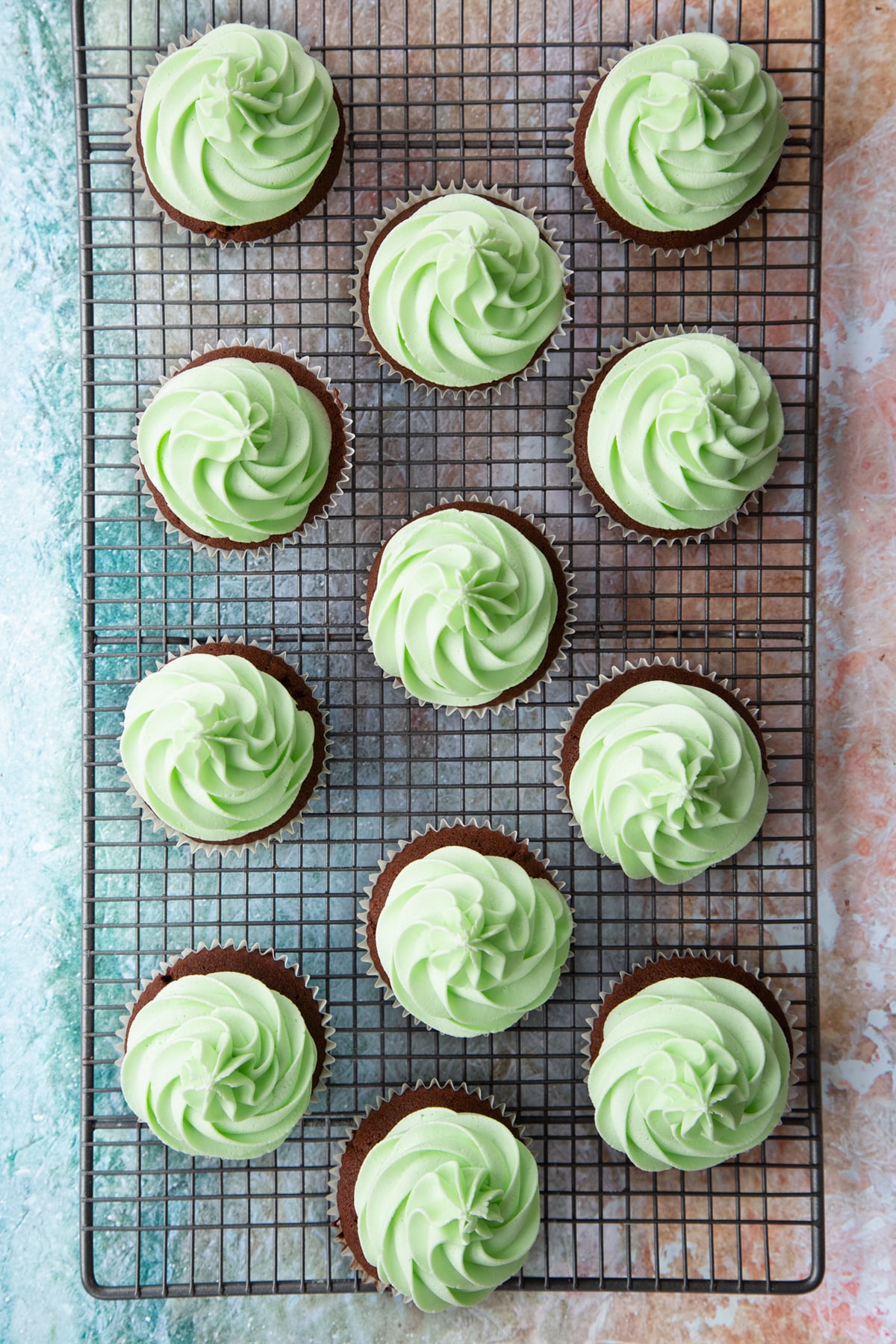 Overhead shot after the mint choc chip cupcakes frosting has been added to the cupcakes.