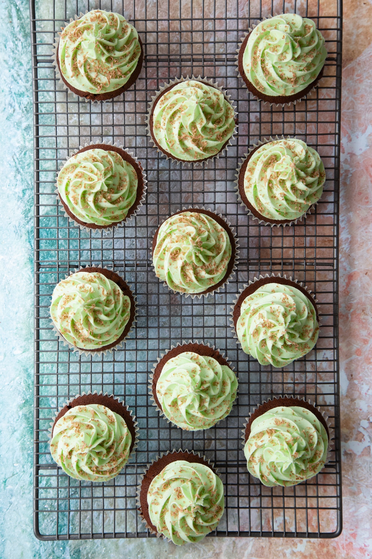 Overhead shot of the finished mint choc chip cupcakes on a cooling rack.