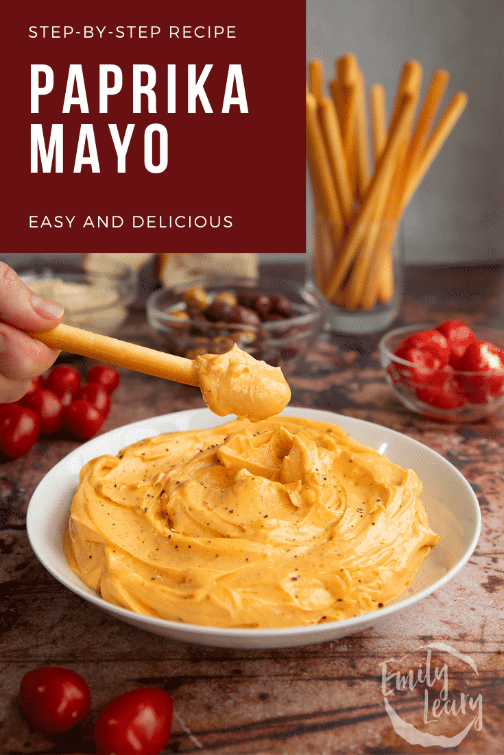 Paprika mayo in a shallow white bowl. A breadstick is being dipped in. Caption reads: Step-by-step recipe. Paprika mayo. Easy and delicious.