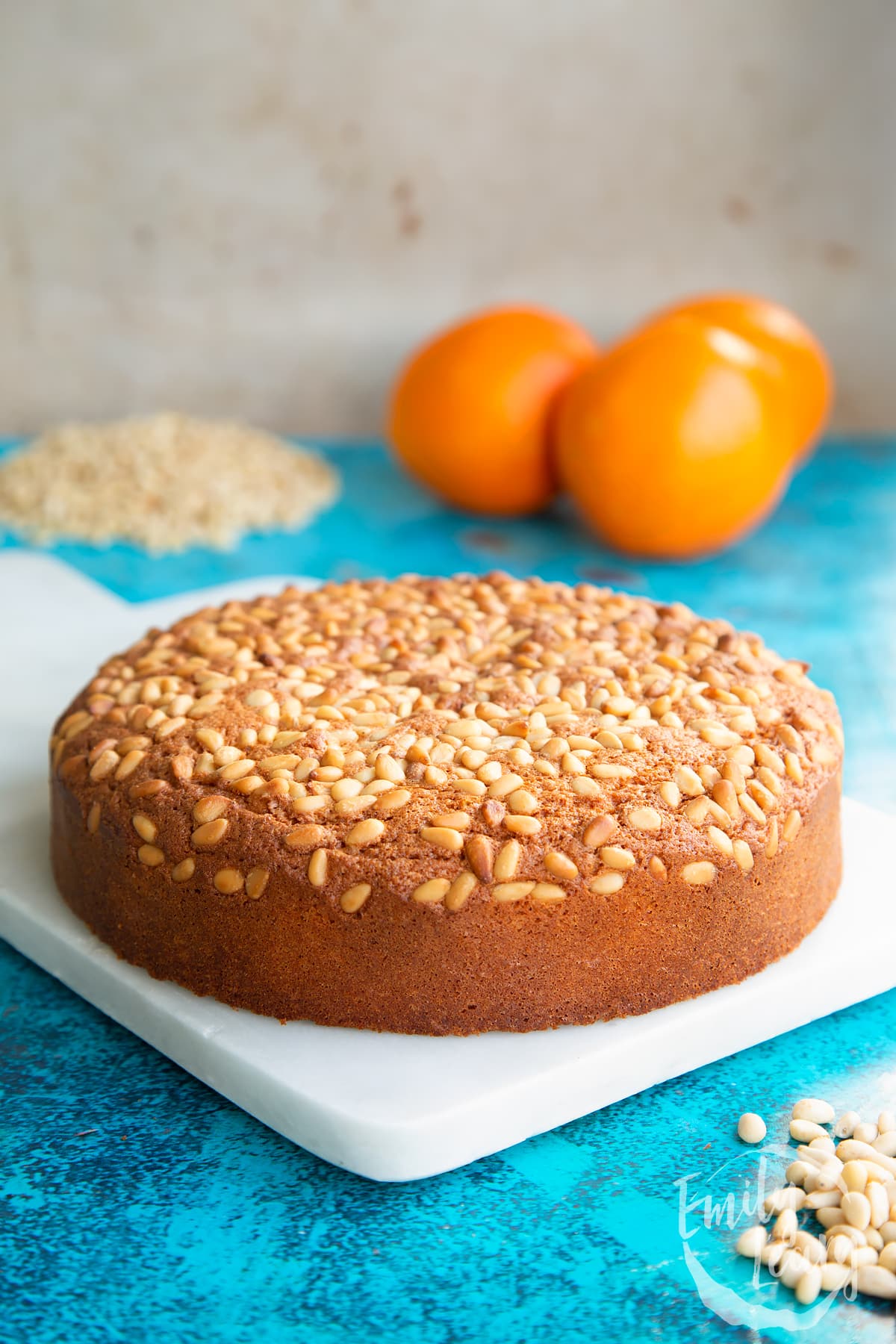 Pine nut cake on a white marble board.
