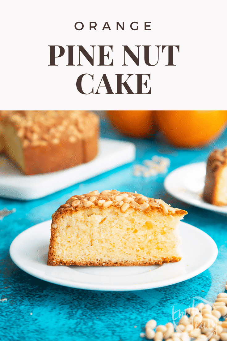 A slice of pine nut cake on a white plate. Caption reads: Orange pine nut cake.