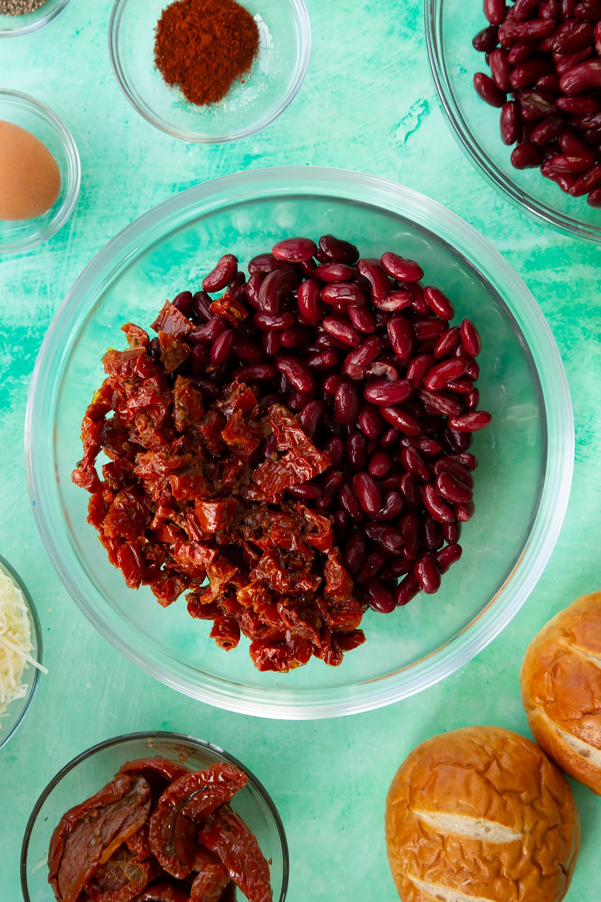 Overhead shot of the chopped sun dried tomatoes and kidney beans in a mixing bowl.