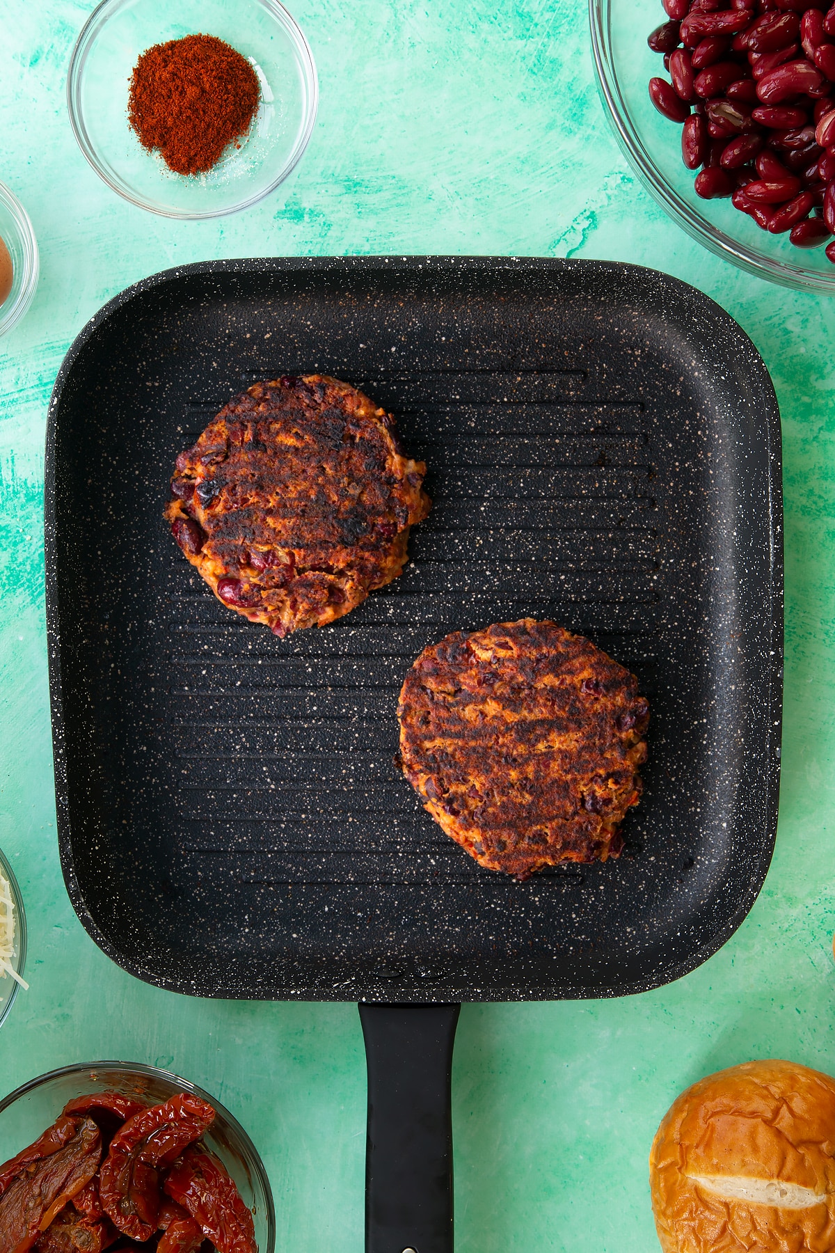 Overhead shot of the burgers having been on the griddle.