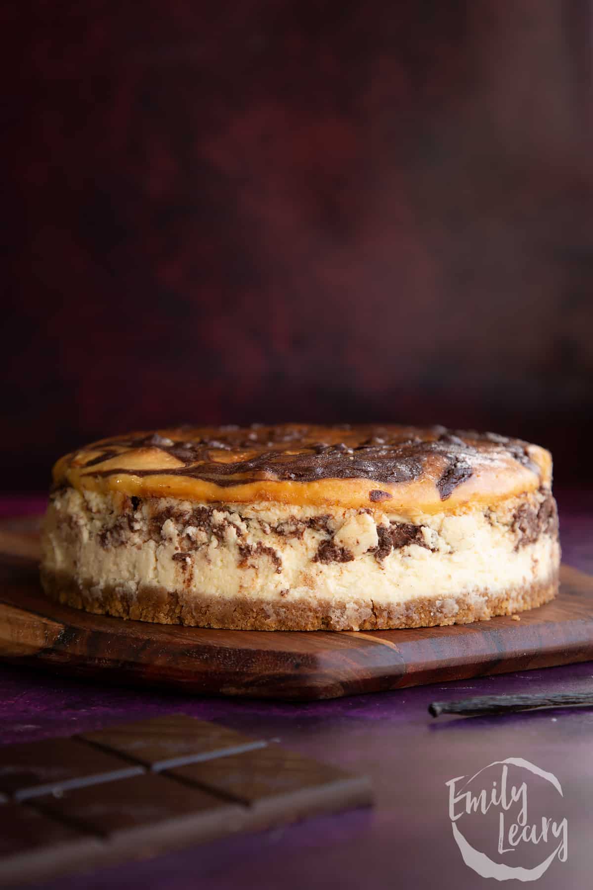 Finished marble cheesecake on a wooden board.