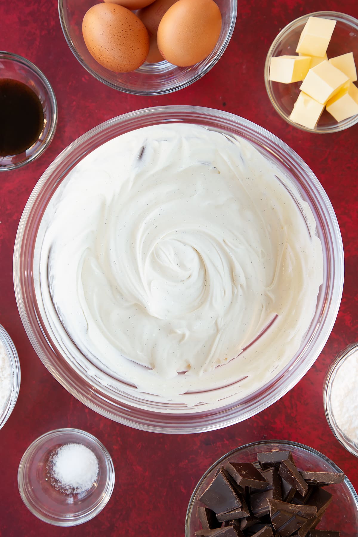 Overhead shot of the cream, icing sugar and vanilla in a bowl having been whisked together.
