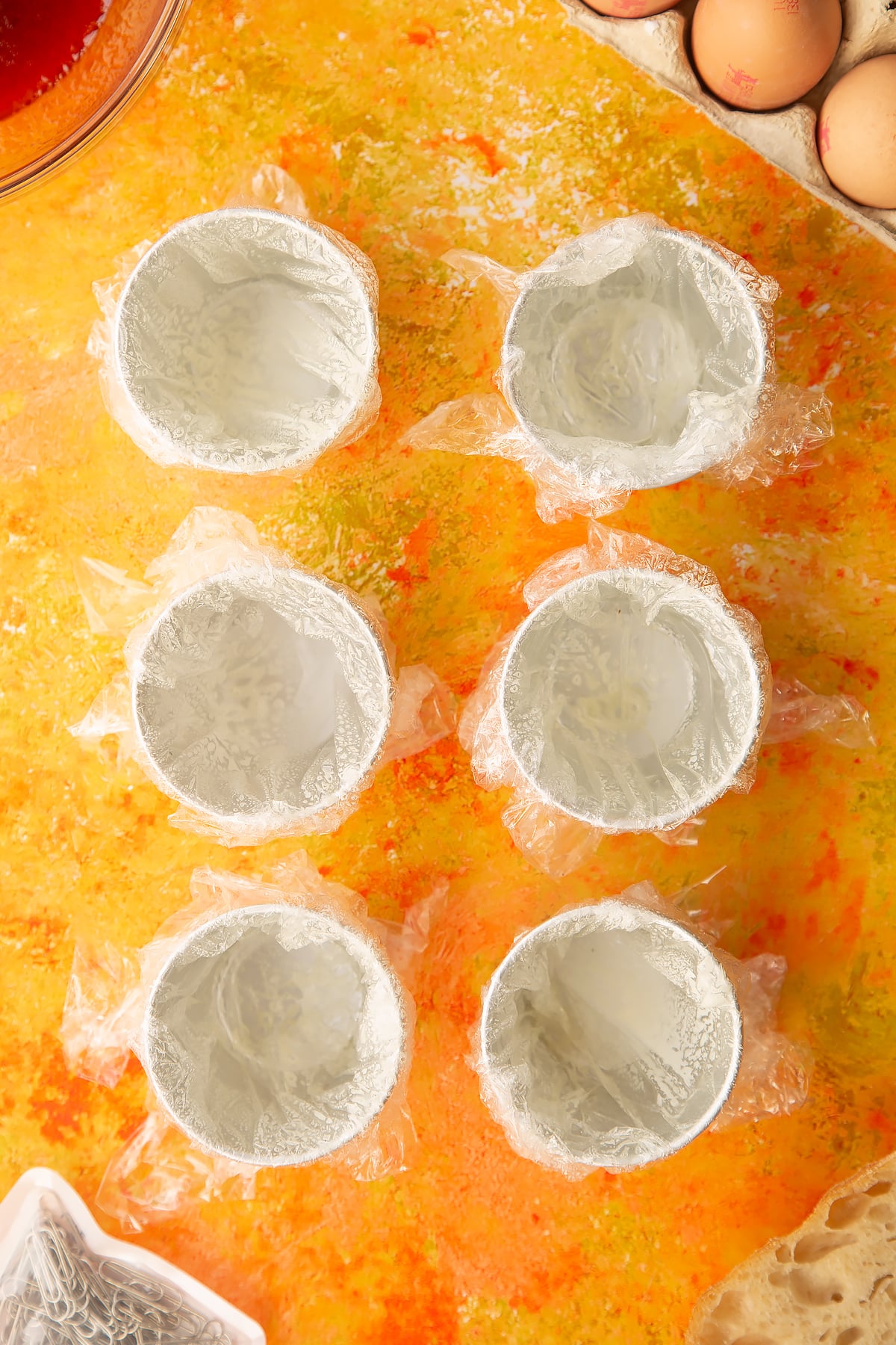 Six small bowls i.e. ramkins covered in clingfilm and sprayed with oil.