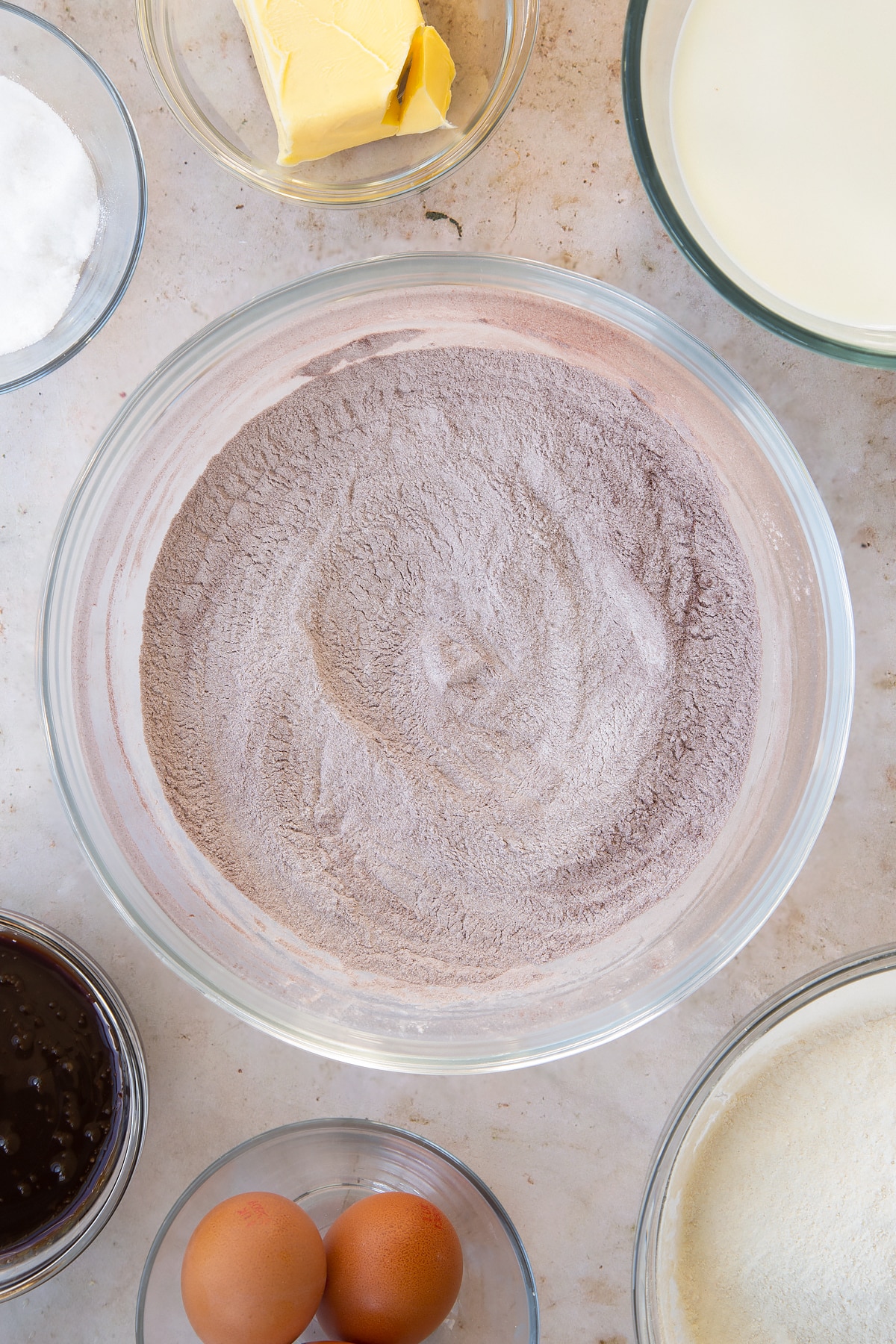 Overhead shot of the red velvet waffles mixture being mixed together in a mixing bowl.
