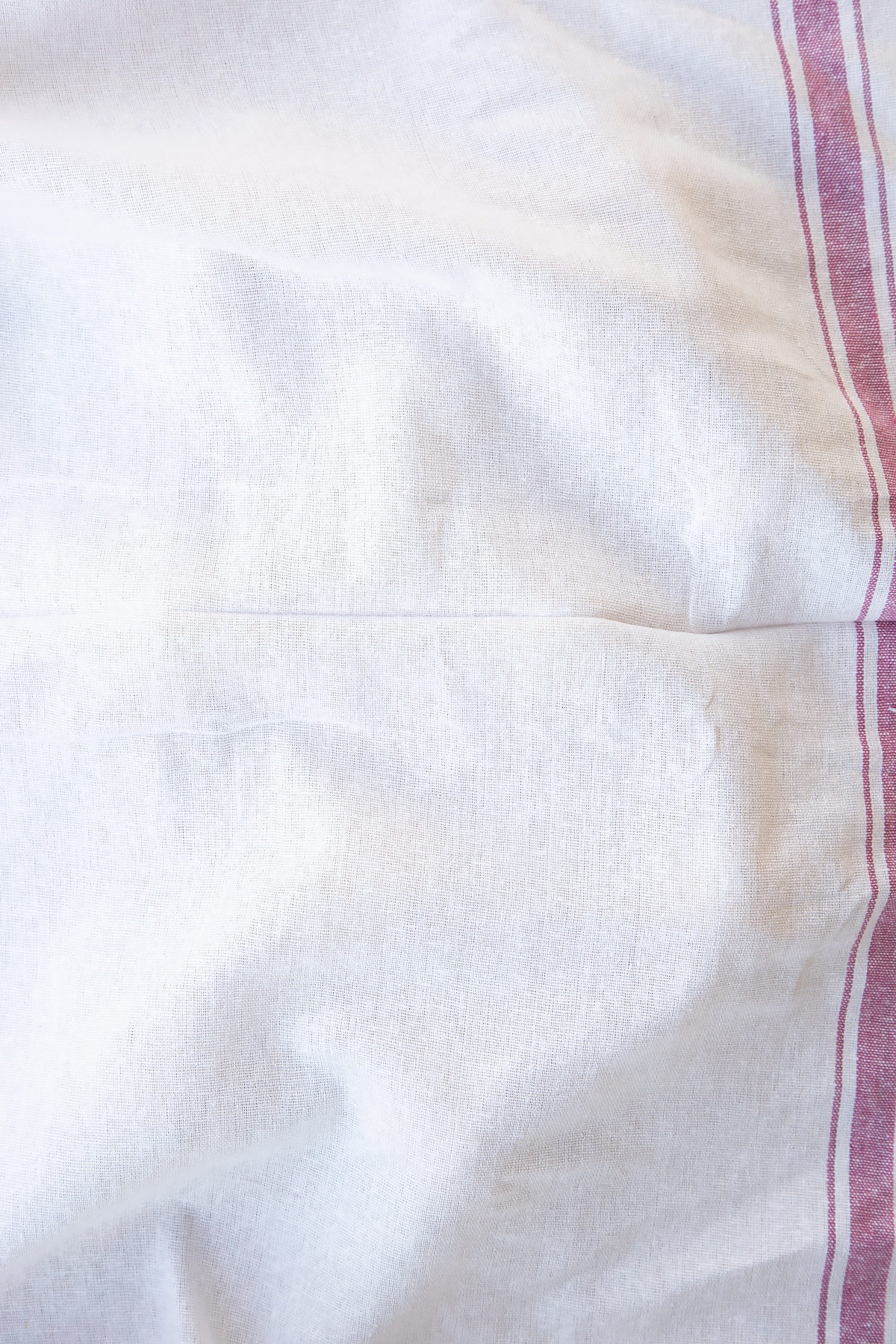 Close up shot of the cloth covering the spiced fruit buns dough for ten minutes.