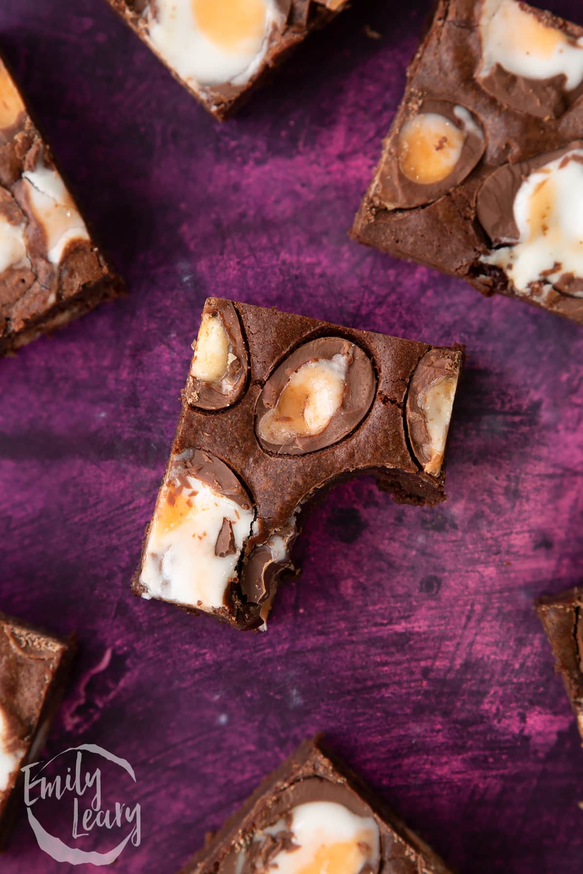 Overhead shot of a Cadbury Creme Egg brownie with a bite taken out.