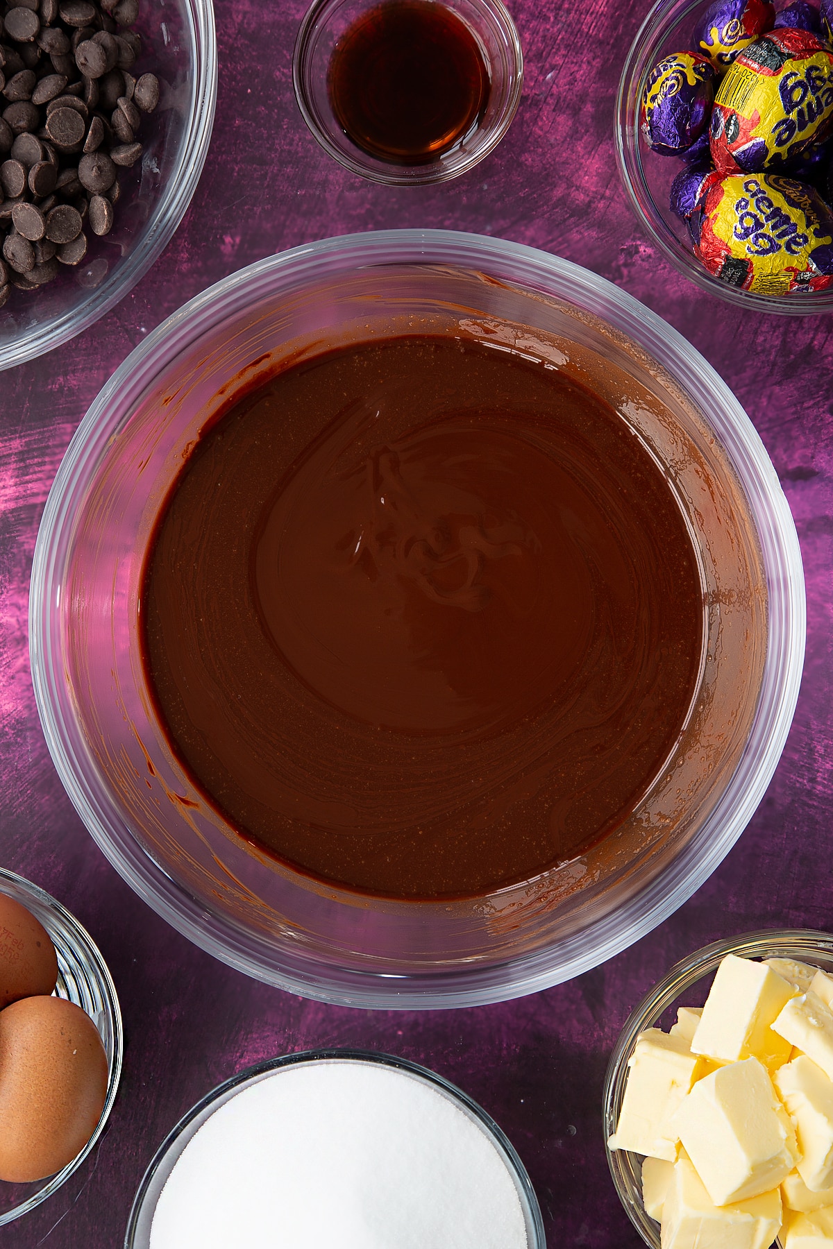 Overhead shot of the melted butter and chopped dark chocolate in a large, heatproof bowl