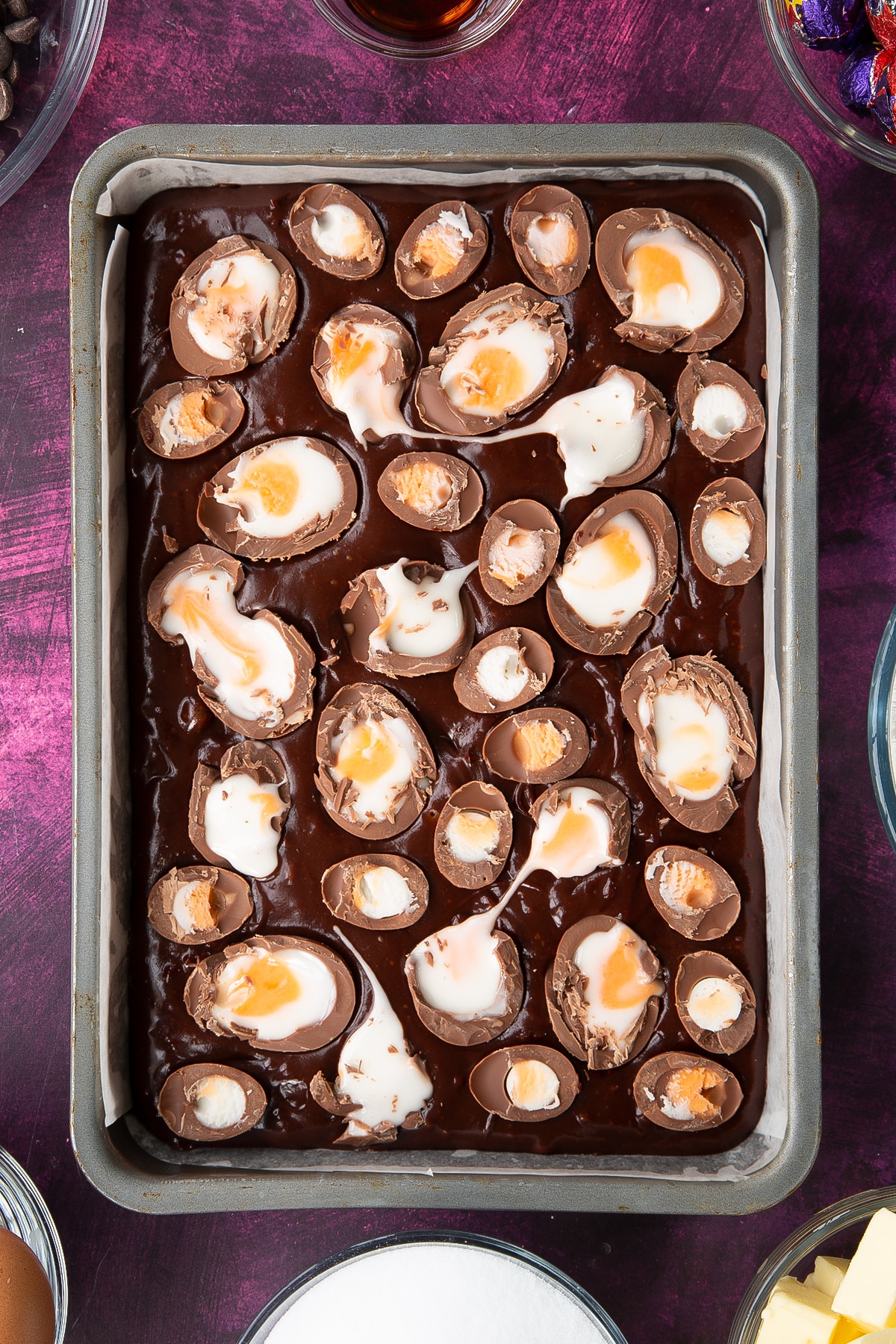 Chopped mini eggs ontop of the brownie mixture.