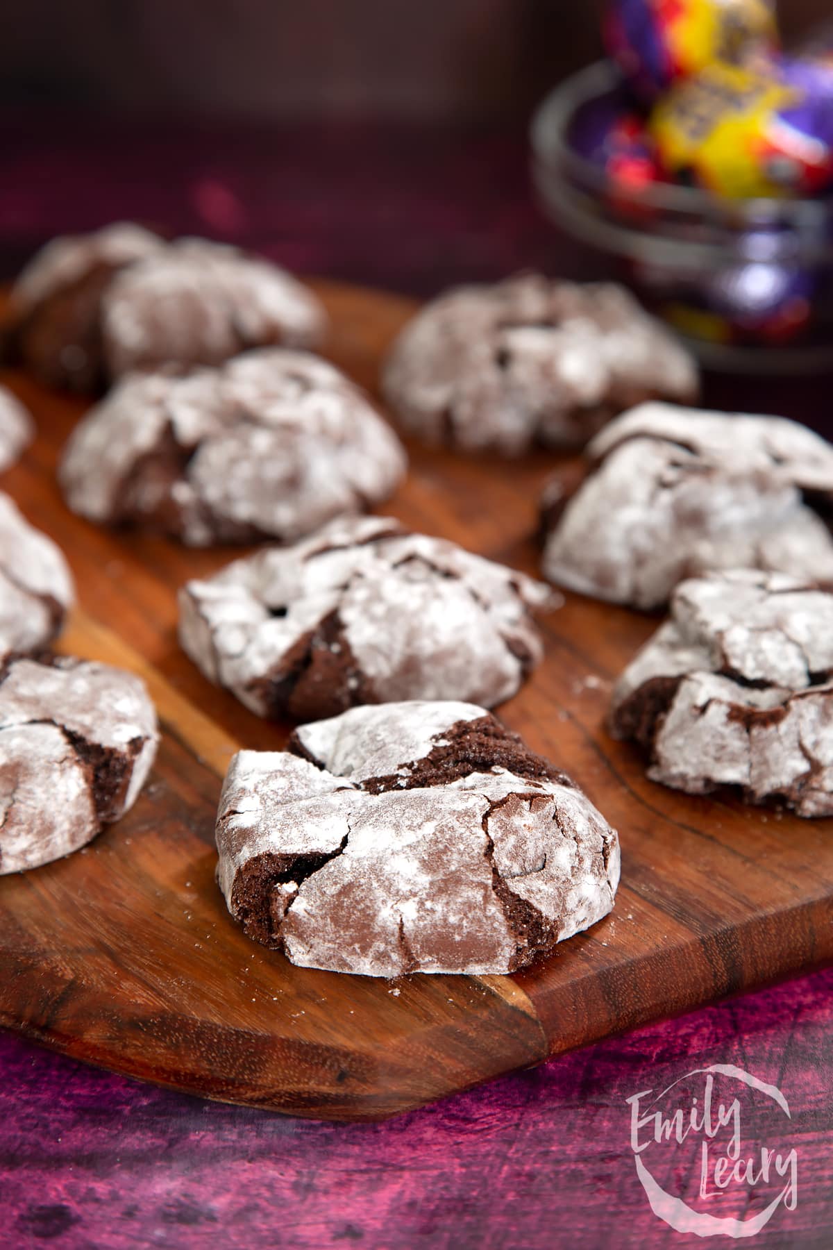 Cadbury Creme Egg cookies on a wooden board.