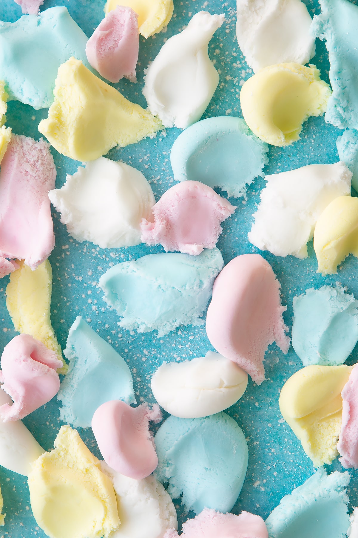 Overhead shot of the different sugar paste pieces on a suface mixed together.