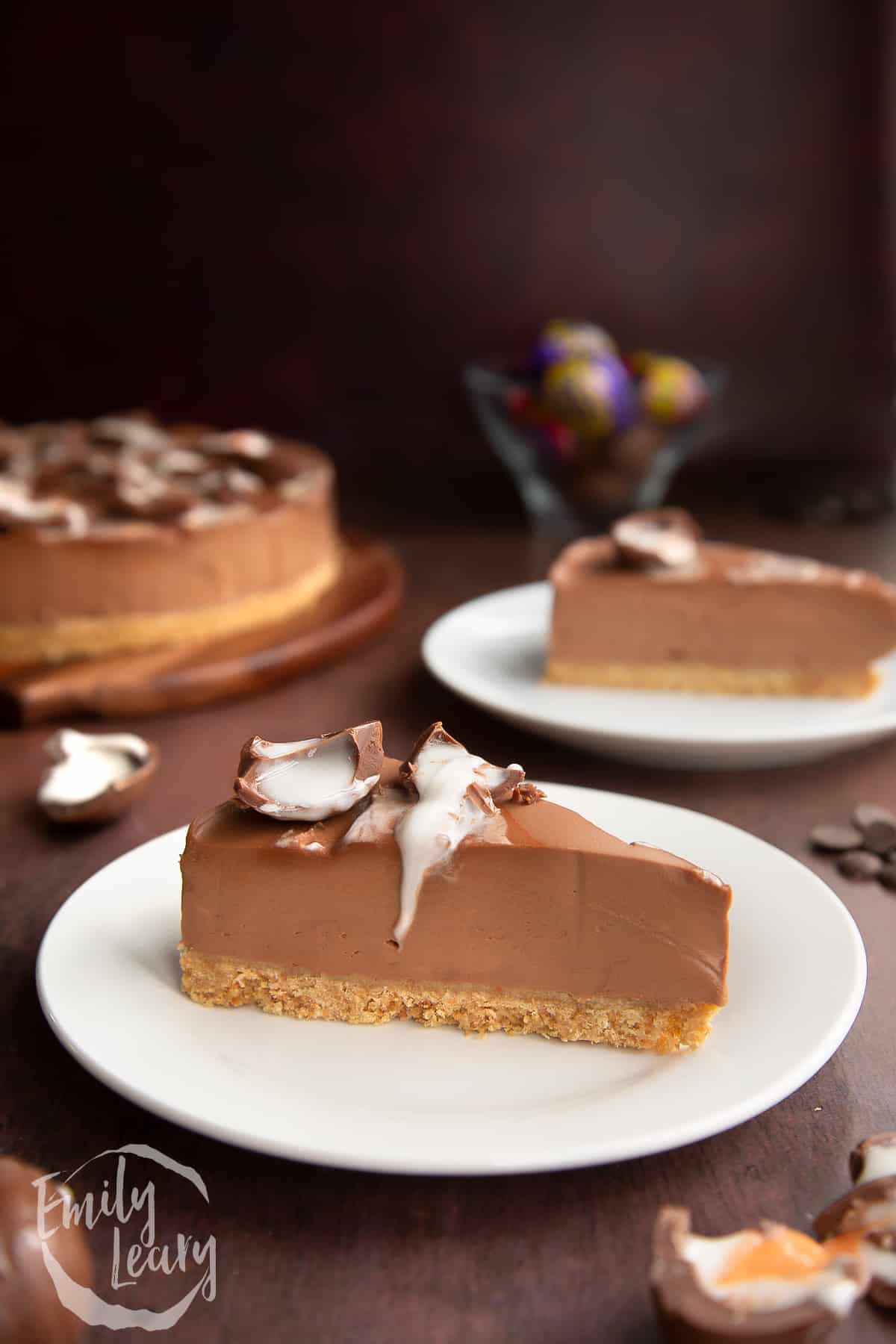 A finished slice of Cadbury Creme Egg cheesecake on a white plate.