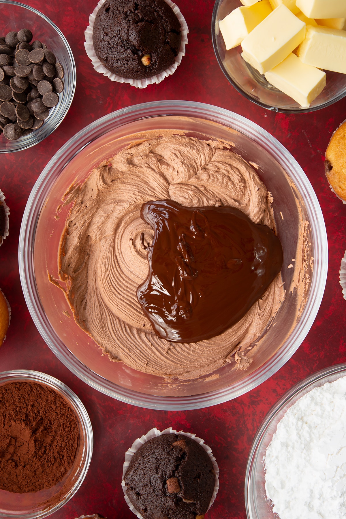 Adding cool melted dark chocolate to the icing.