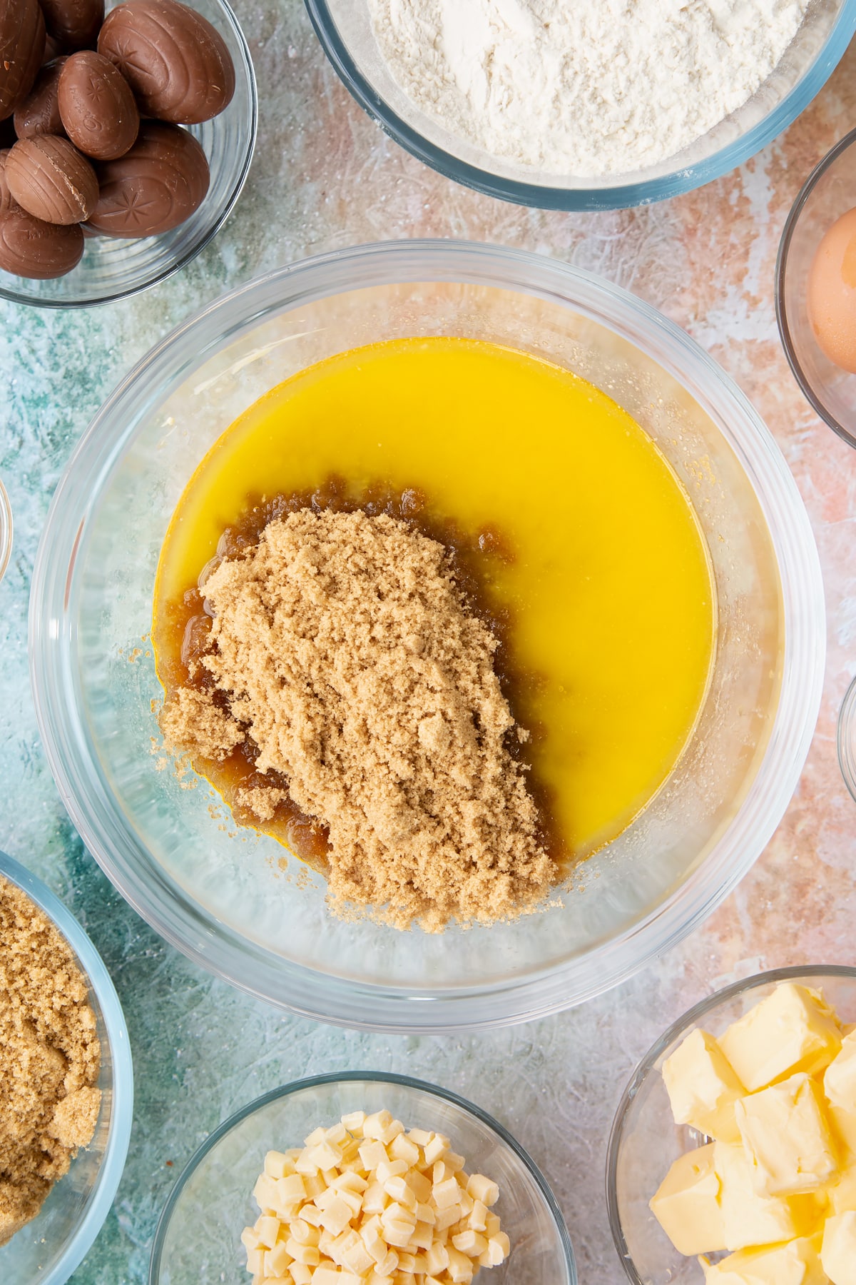 Overhead shot of a mixing bowl filled with melted butter and brown sugar.
