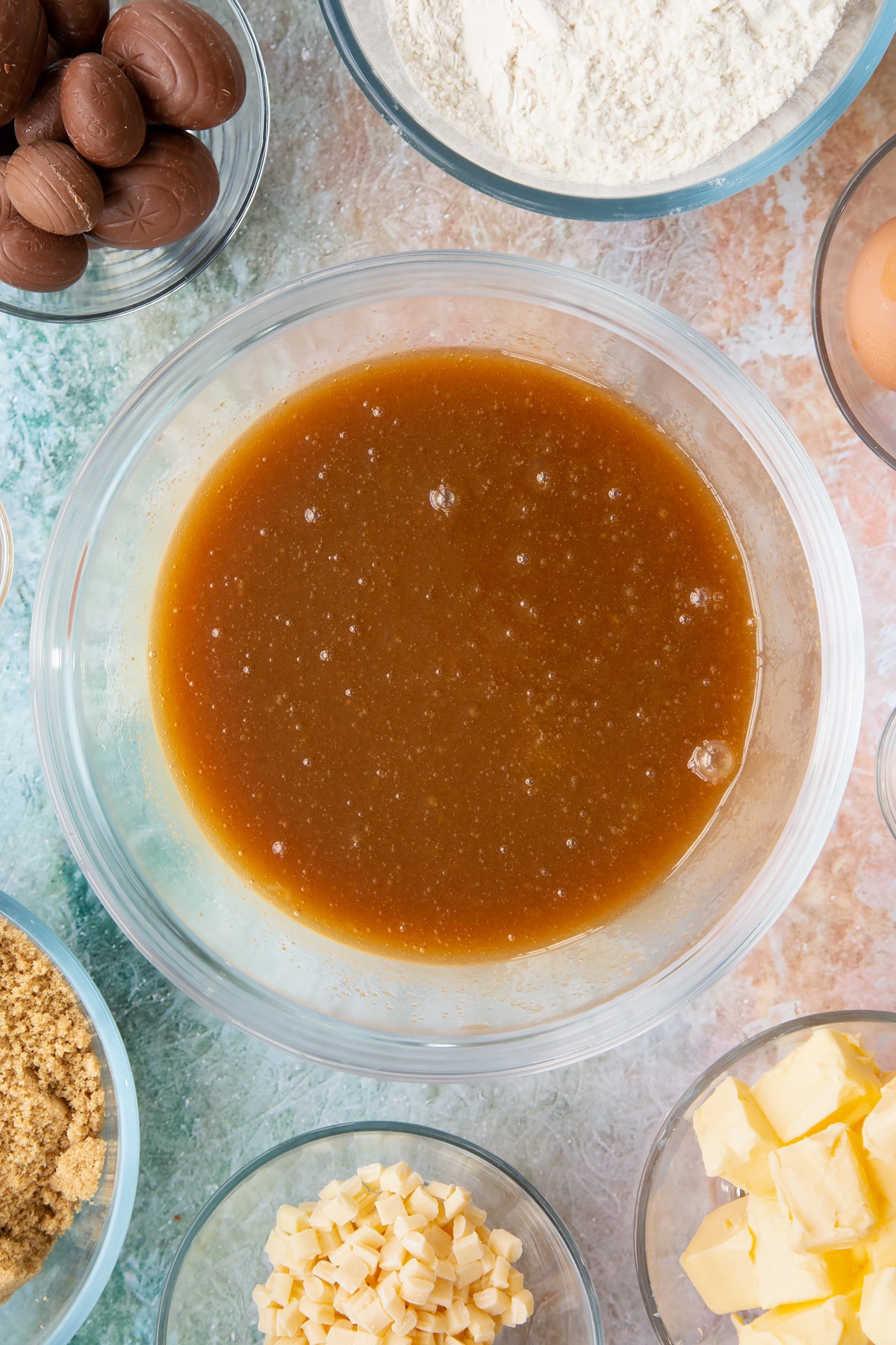 Overhead shot of butter, eggs and brown sugar having been whisked together.