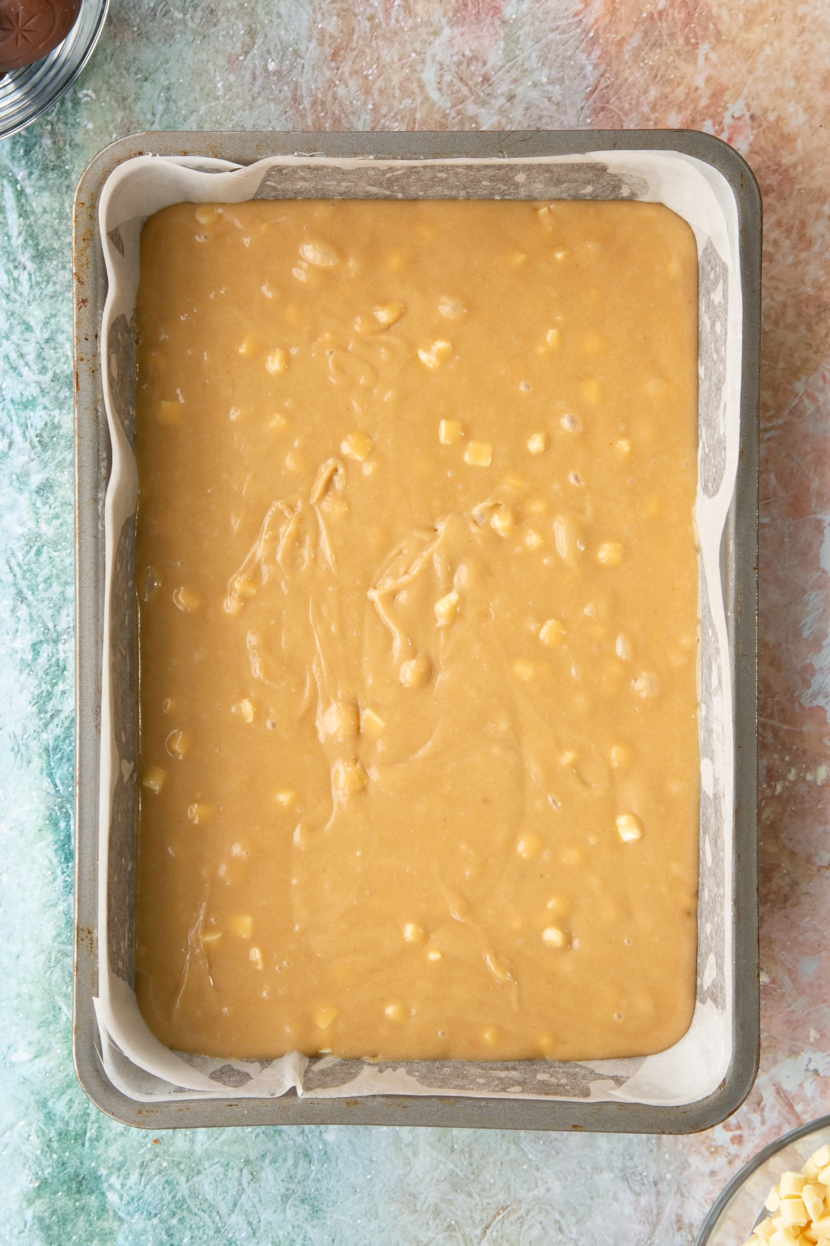 Overhead shot of a baking tin with the wet easter blondies mixture inside.