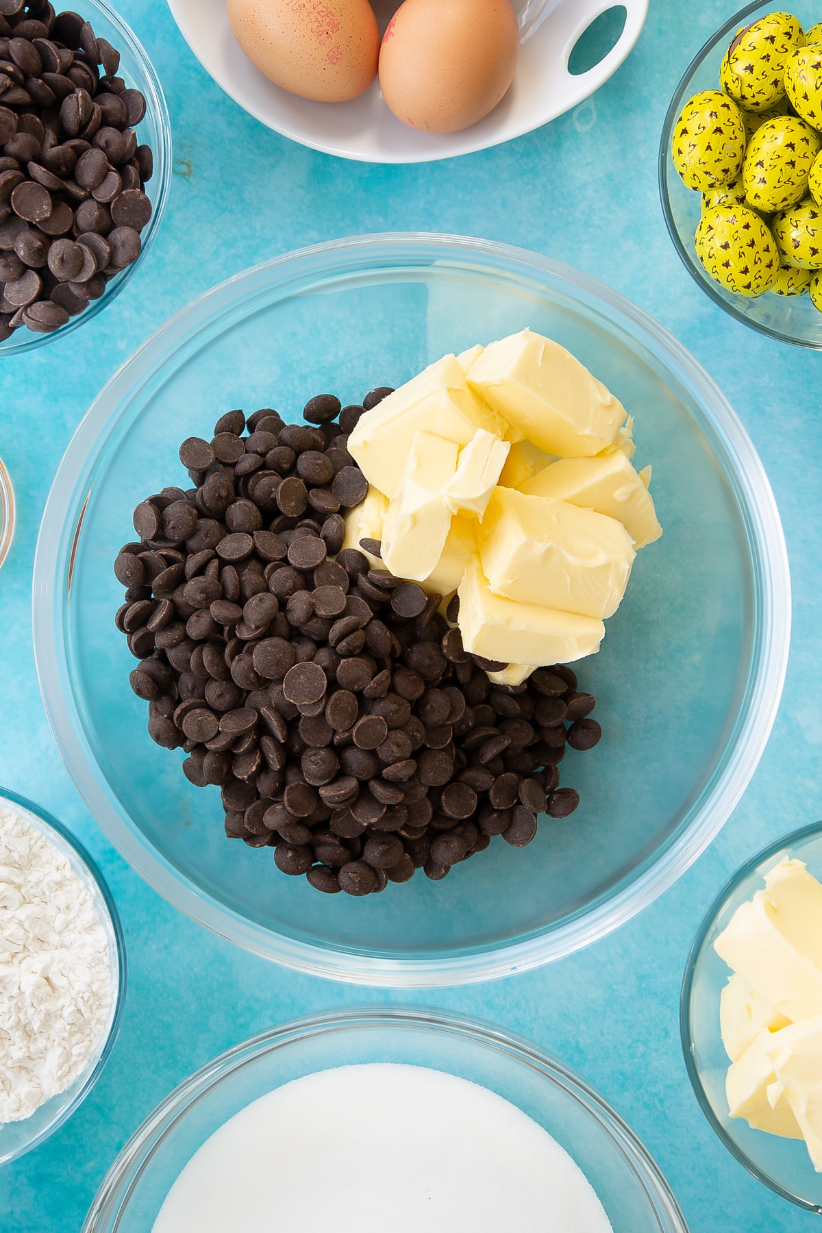 Ovehread shot of butter and chocolate chips in a mixing bowl.