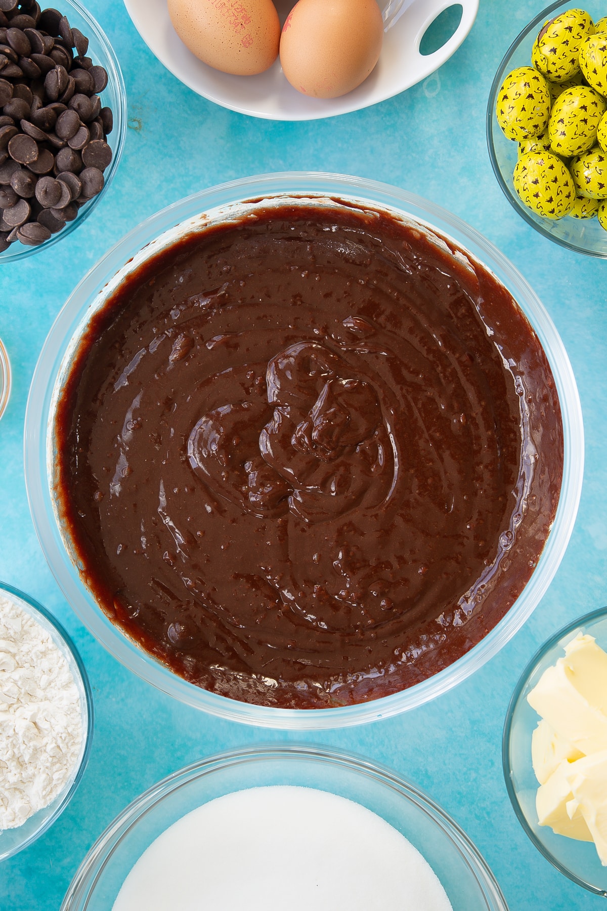 Overhead shot of the easter brownies wet mixture being folded together in a mixing bowl.