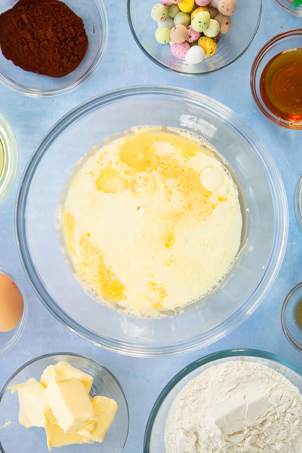 Sugar, beaten eggs, oil, milk and golden syrup in a mixing bowl.