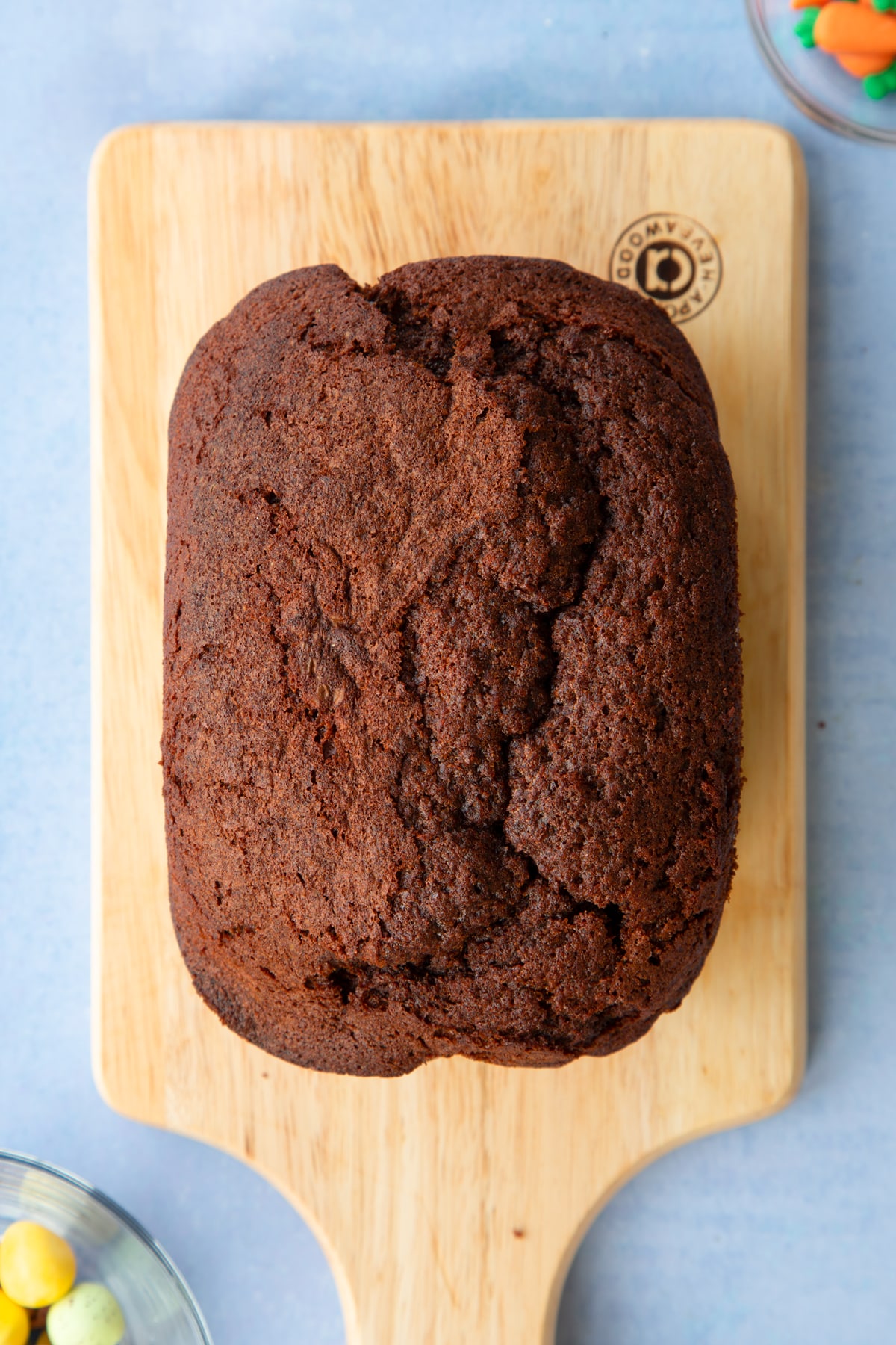 Finished Easter loaf cake on a wooden chopping board.