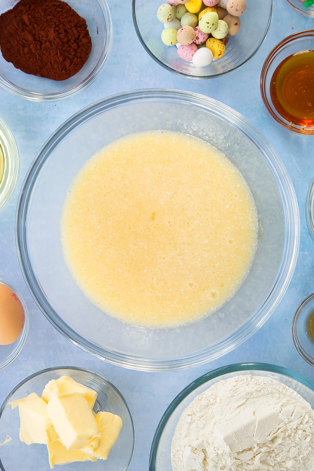 Sugar, beaten eggs, oil, milk and golden syrup having been whisked together.